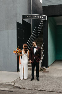 Modern bride and groom walk through inner city streets of melbourne
