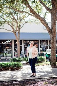Mahlia wearing a mint top and rose gold jacket