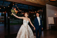 Bride and groom excited during their grand entrance to their wedding reception