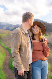 open field couple mountainside couple in open field for engagement photos in bay area california.