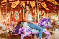 Senior portrait at the Greater Gulf State Fair in Mobile, Alabama — smiling on the carousel as
her hair blows in the wind.