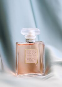 Styled product photography of luxury perfume bottle photographed with soft light to highlight glass, color, and form
