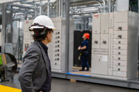 a person watching someone work in a warehouse
