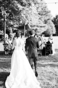 Newlyweds entering their outdoor reception together in wedding photography Detroit MI