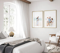 Two framed Destin beach family portraits styled as wall art in a bright coastal bedroom
