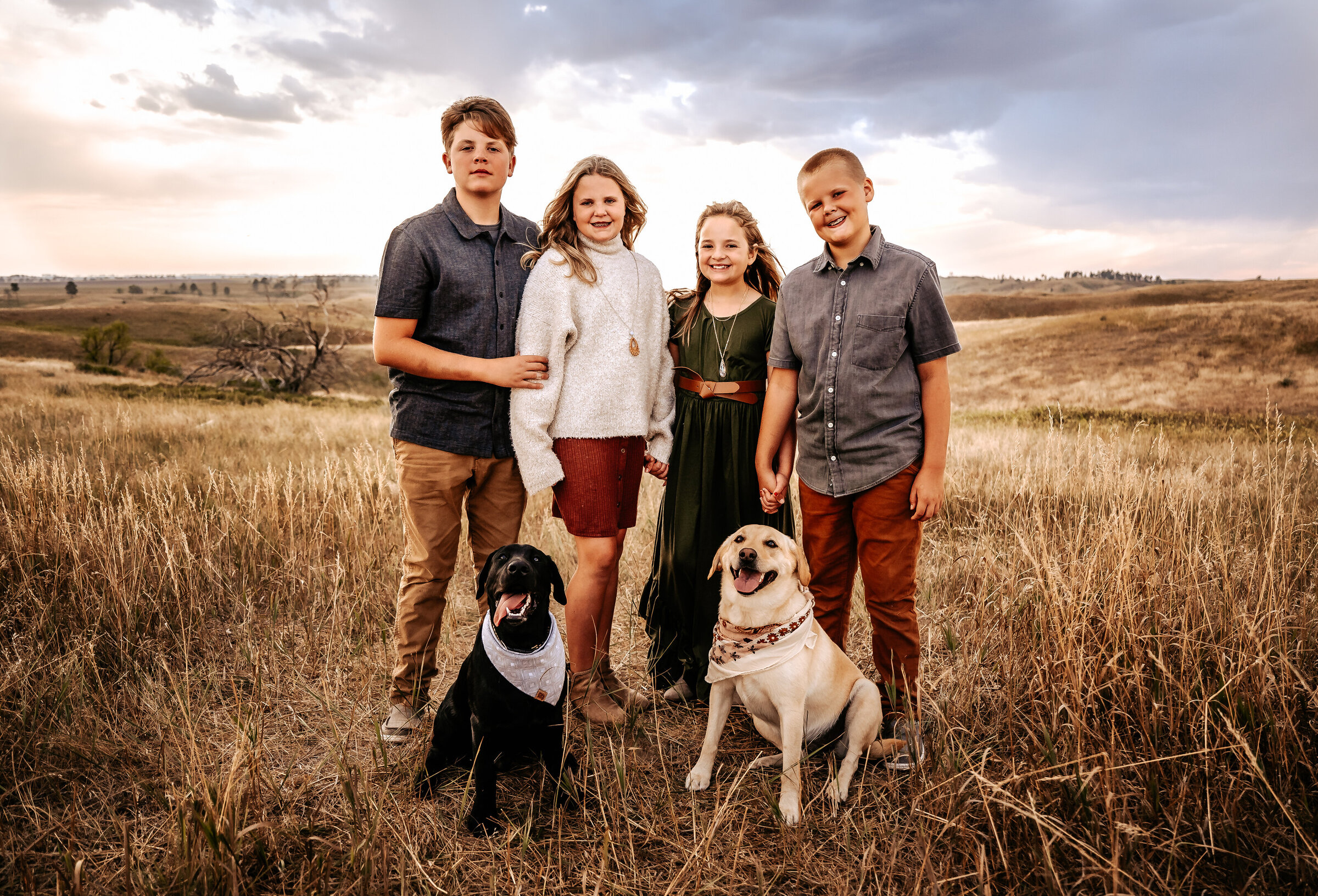 Siblings stand with their two dogs for family photos in Chadron State Park