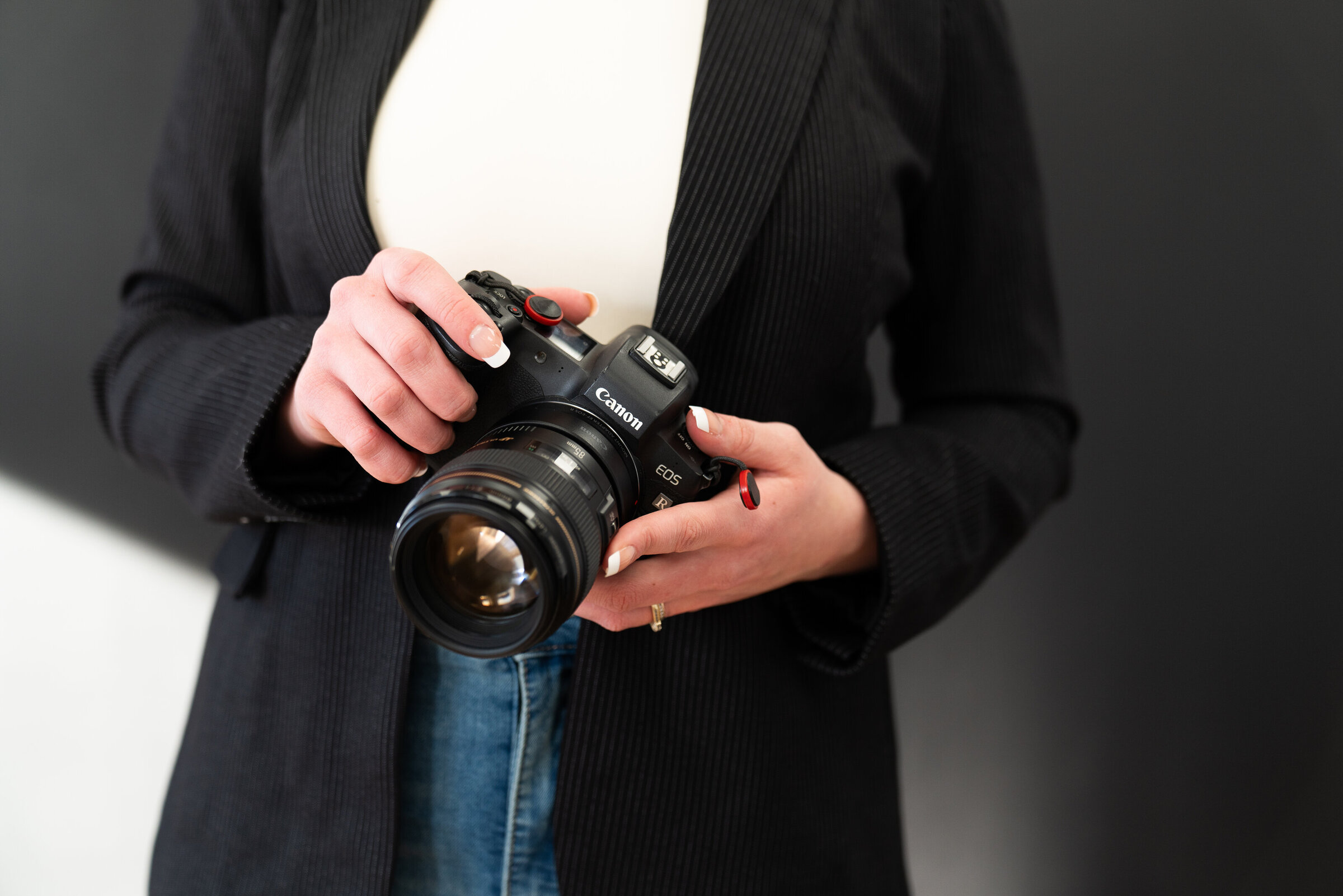 Photographer holding her camera for a detail shot during her headshot and branding photo shoot