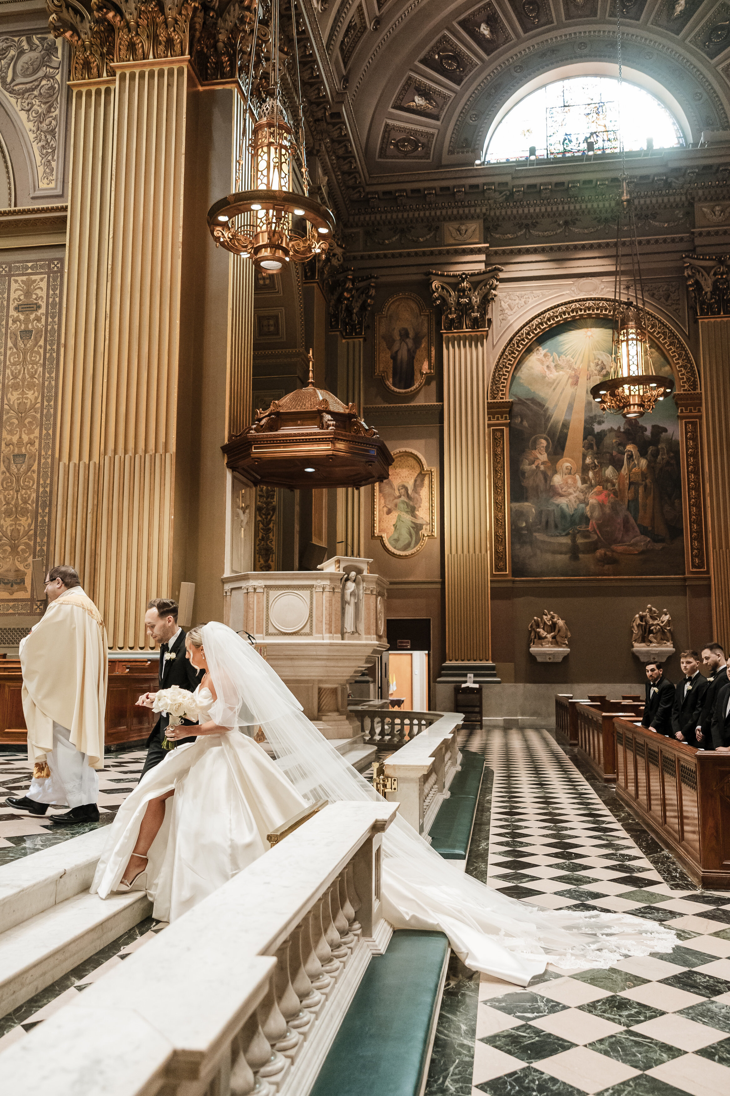 Bride and groom walking up the alter at Cathedral Basilica of Saints Peter and Paul wedding ceremony in Philly.