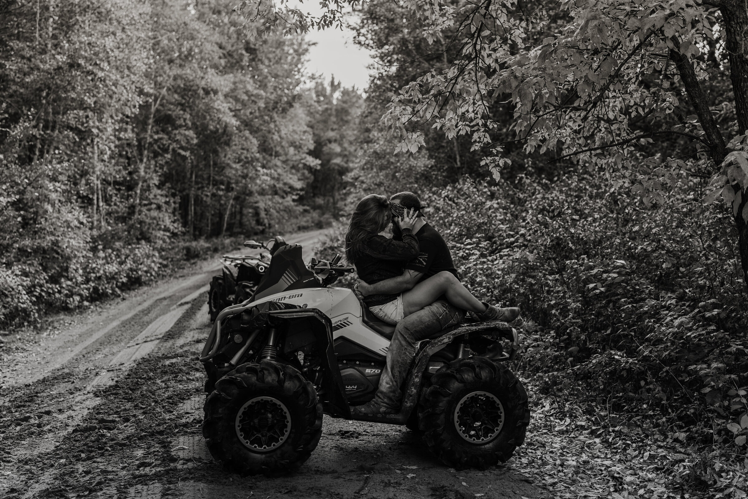 Couple sitting on ATV looking at each other