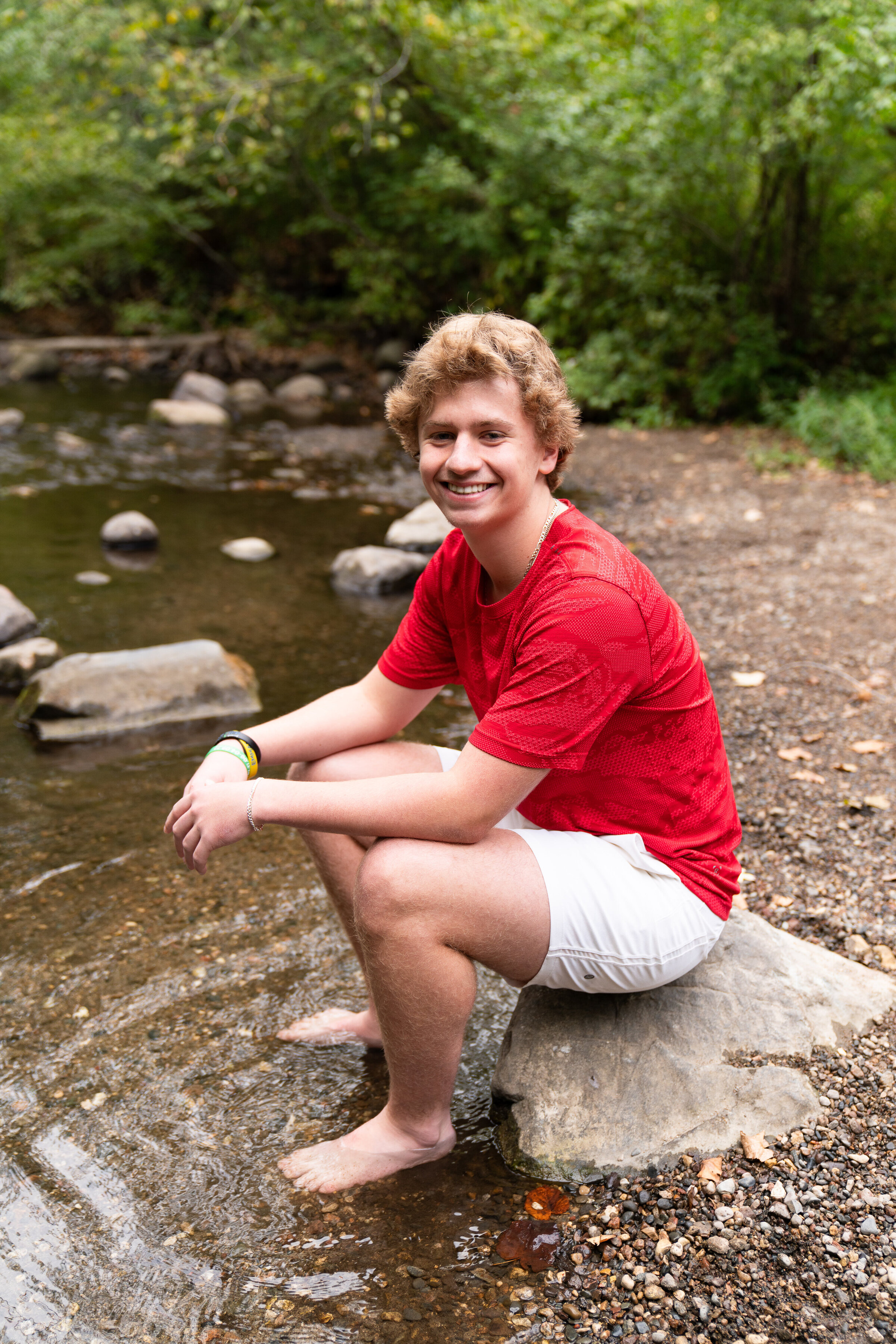 Guy sitting on a rock for his senior pictures
