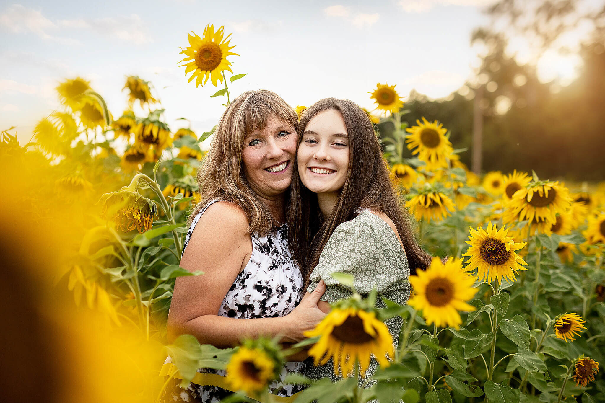 mother and daughter hugging in sunflower field in Galion Ohio