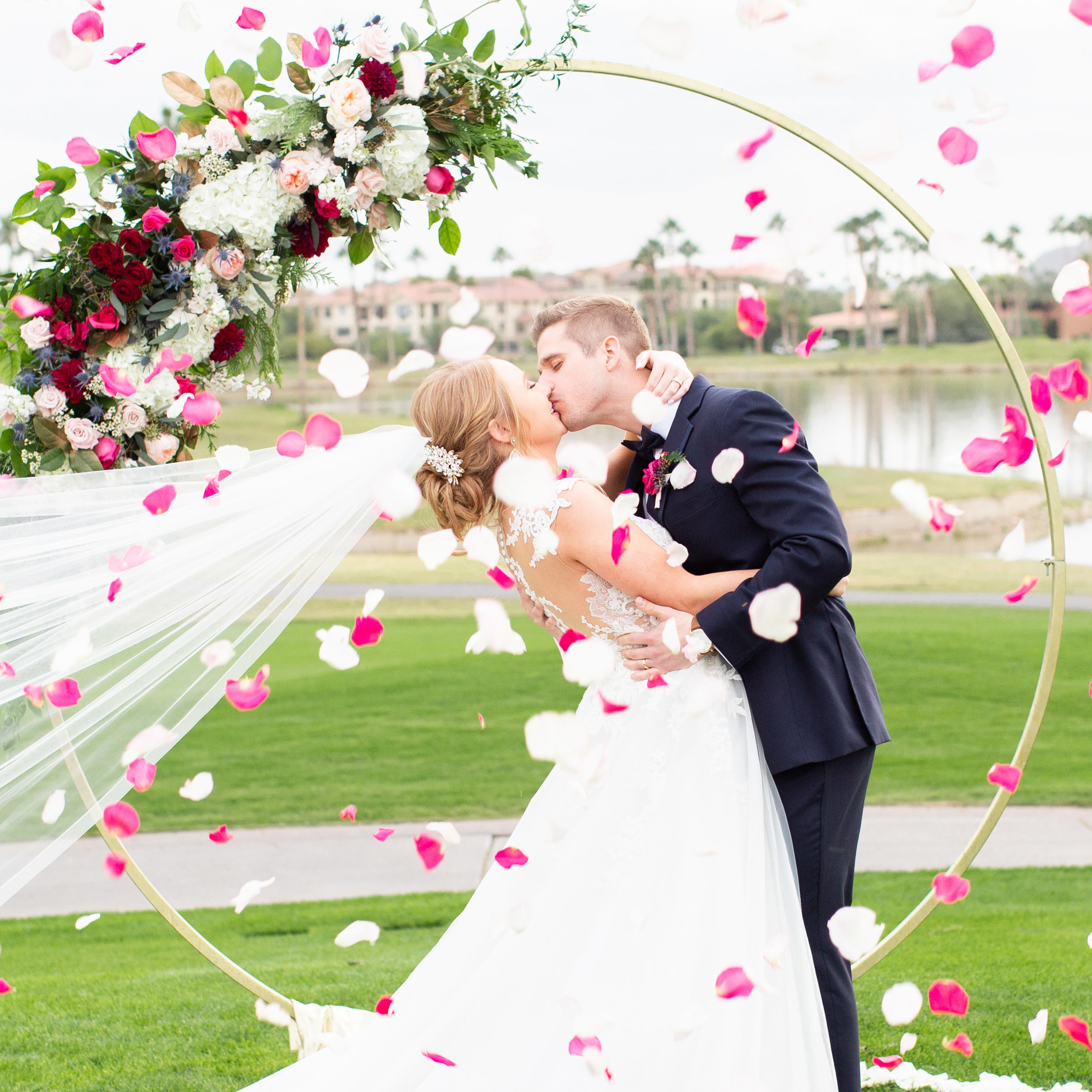 bride and groom kiss flower petals