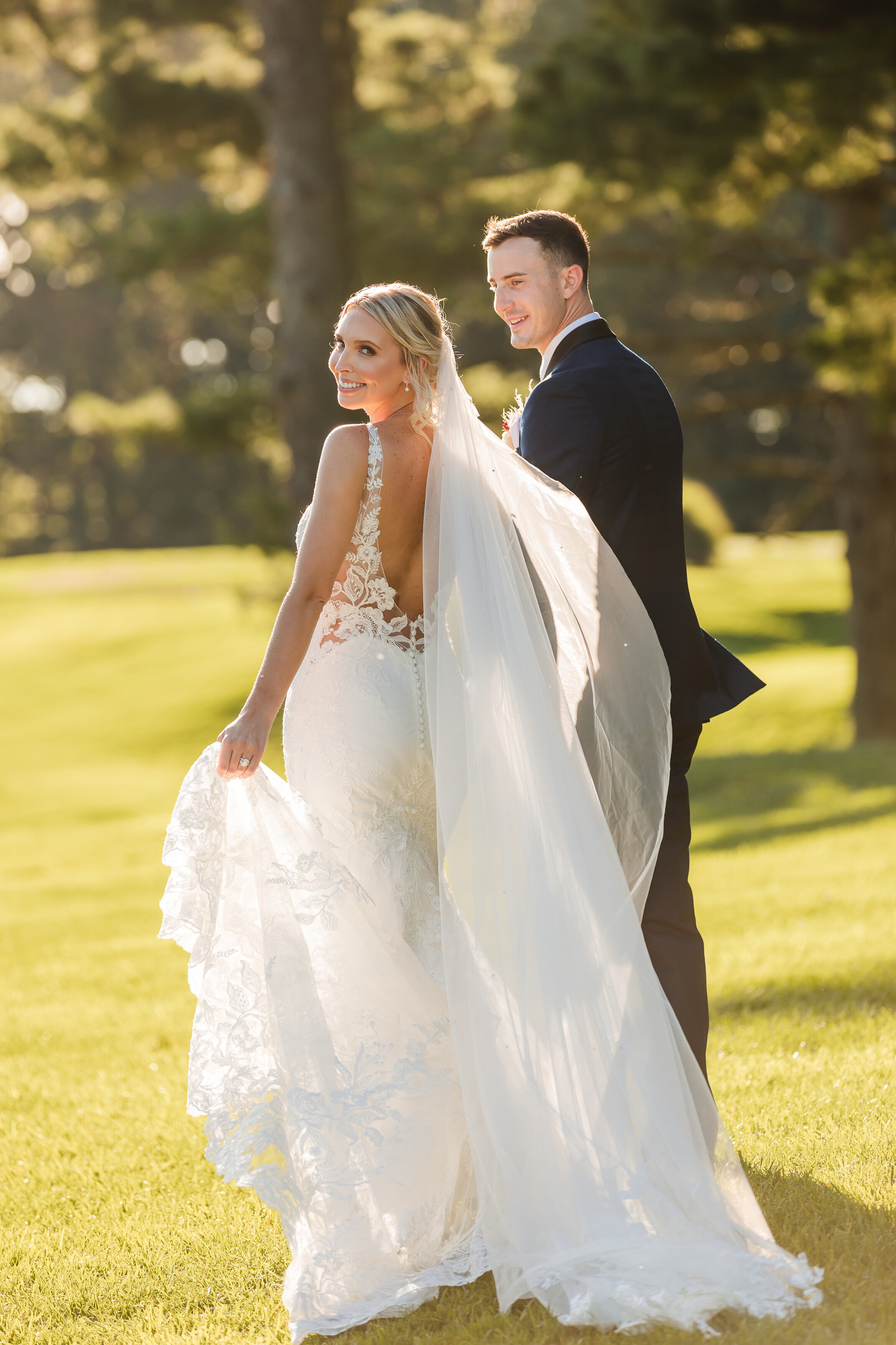 Bride and groom walking at Park Chateau after their wedding ceremony during the golden hour.