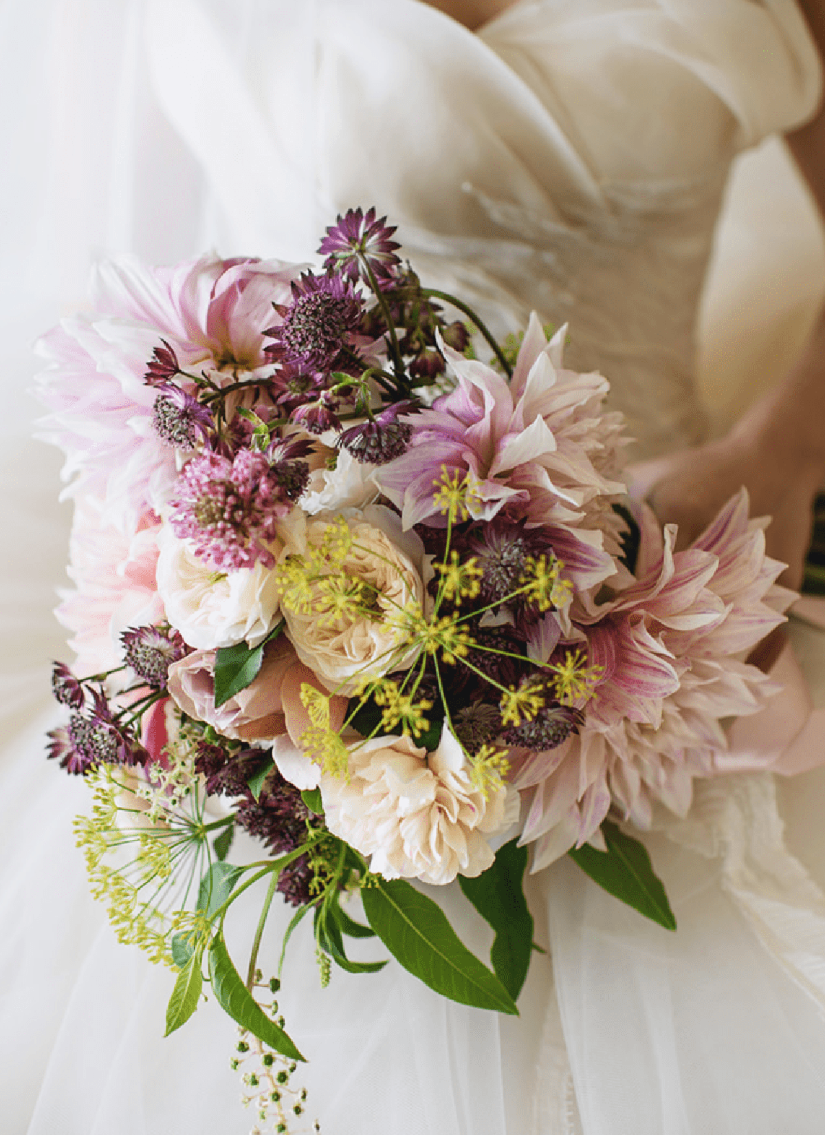 Bride holding pink and purple flower bouquet