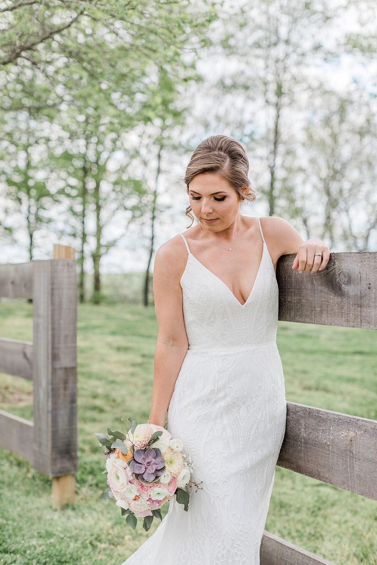 Bride holding her soft spring inspired bouquet with succulent
