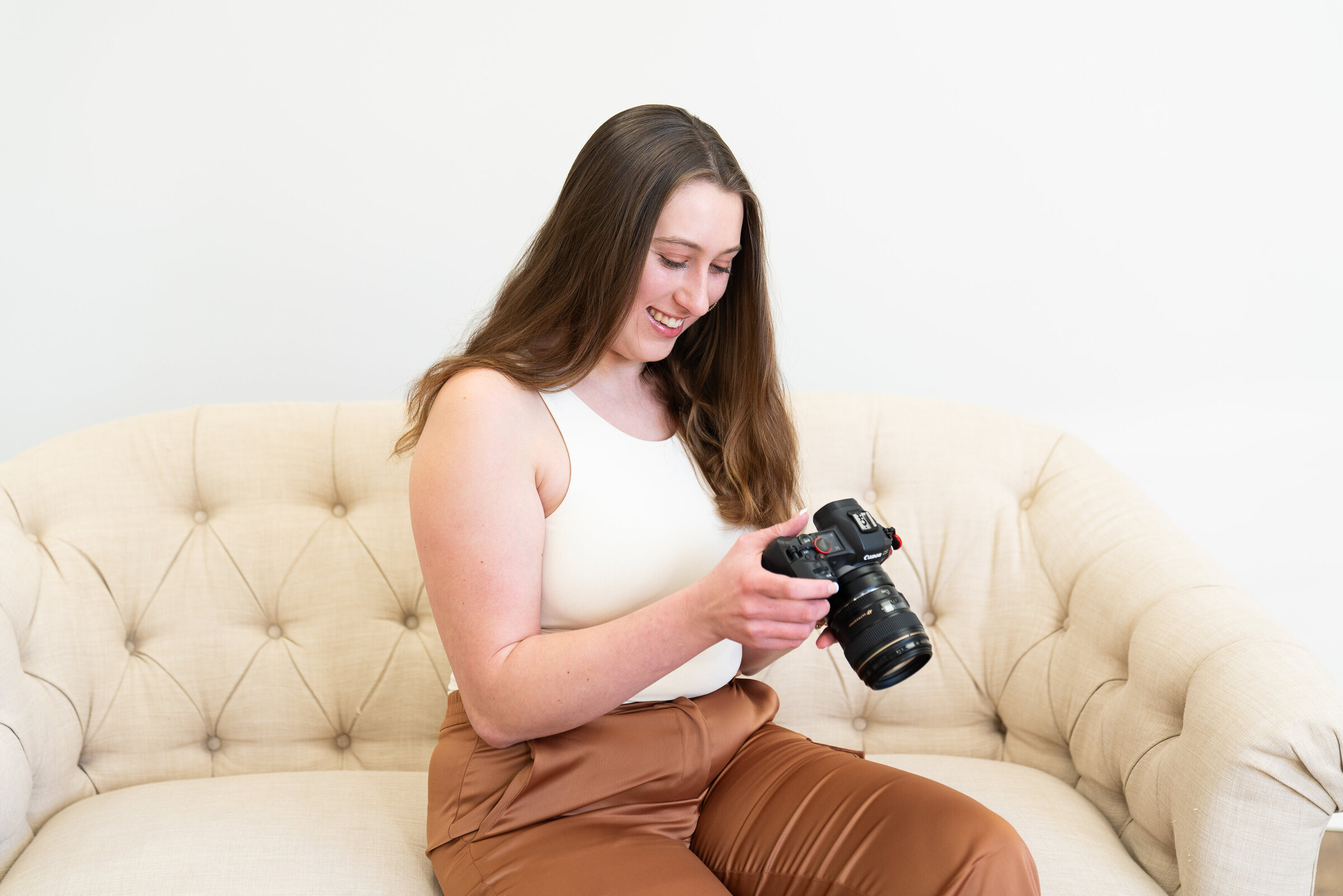Woman looks at her camera and smiles
