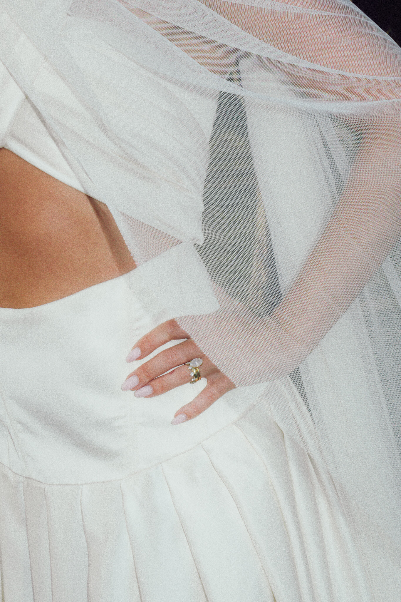 Close-up bridal detail of a wedding gown and engagement ring, captured in a soft, cinematic style by a luxury documentary wedding photographer UK.