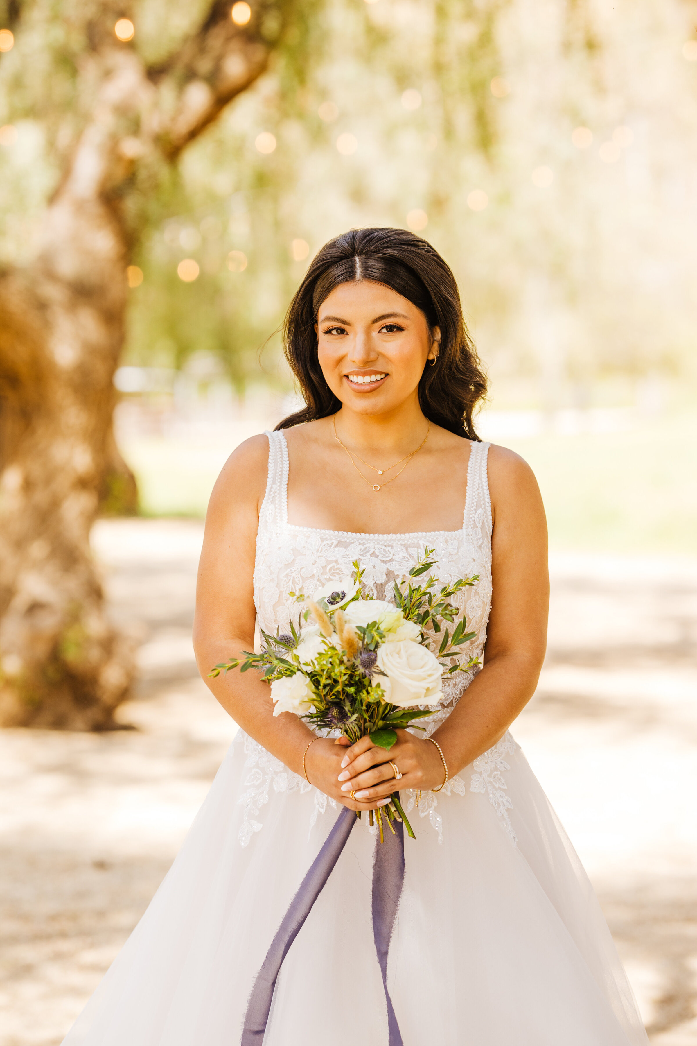 A woman in a white wedding dress holding a bouquet of flowers.