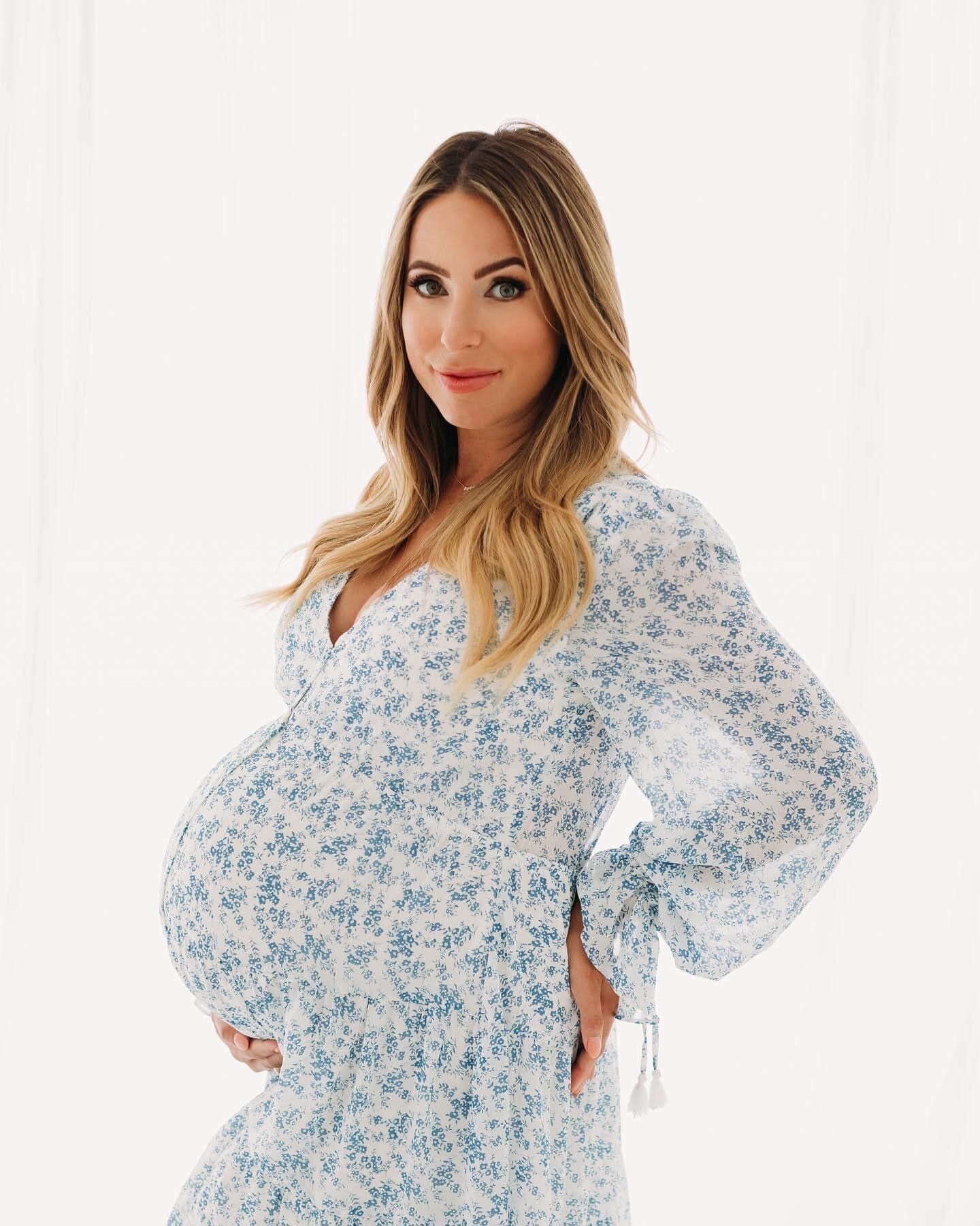 A pregnant woman in a blue and white dress