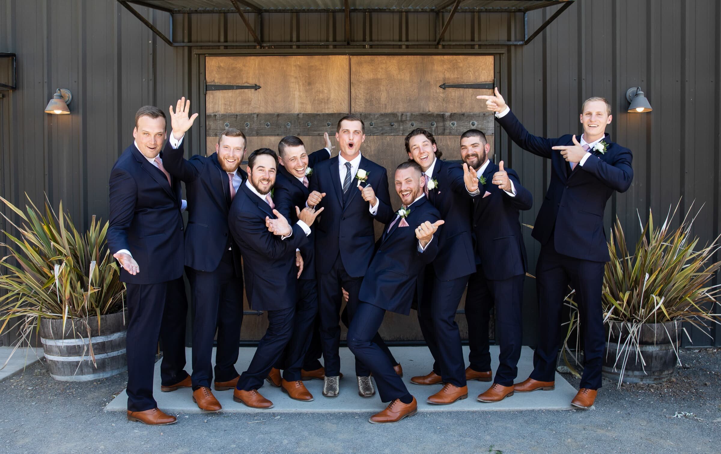 groom and groomsmen being silly during wedding party portraits on a wedding day.