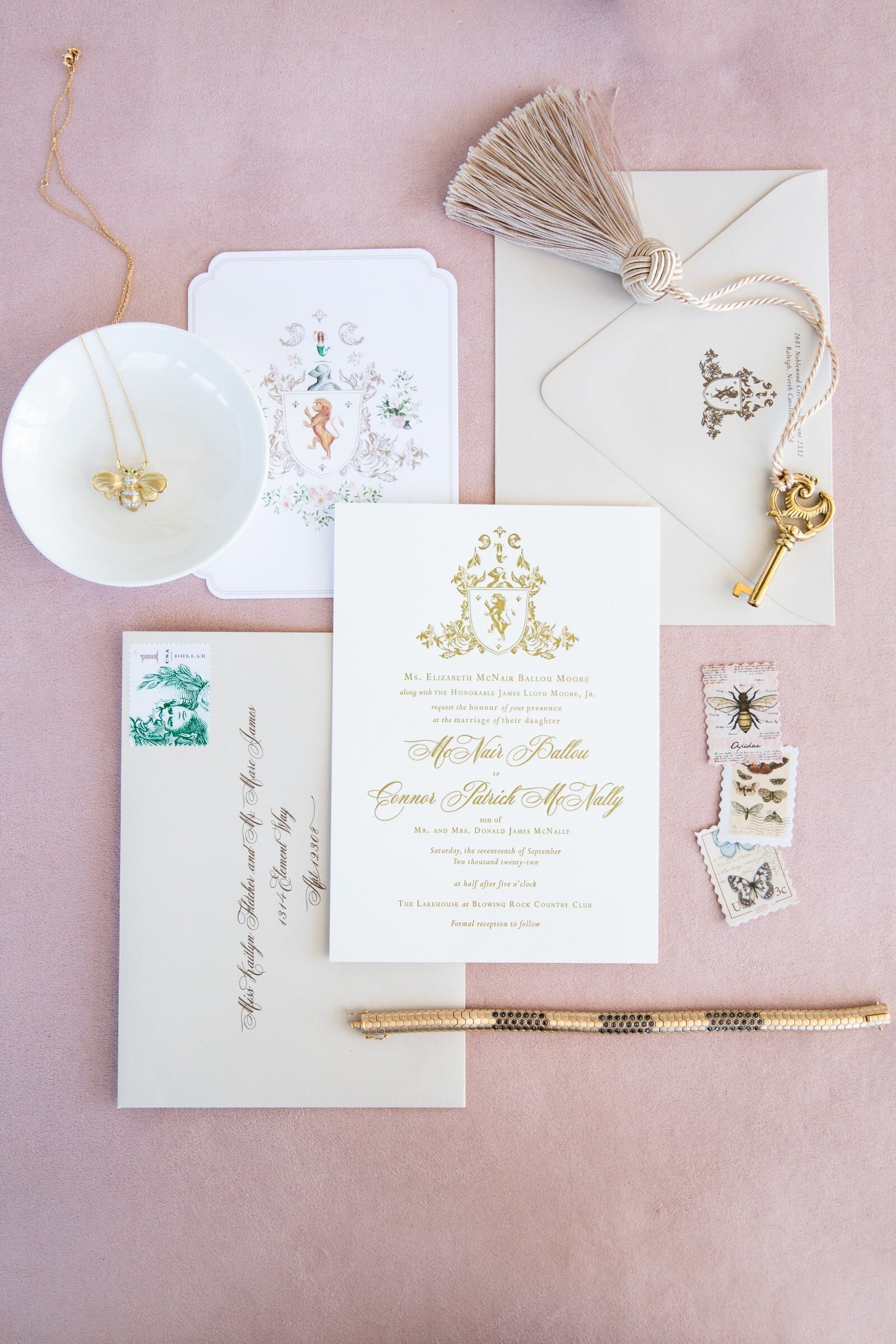 White and Gold custom wedding invitations against pink velvet backdrop. Wedding flat lays at the Merrimon-Wynne wedding.
