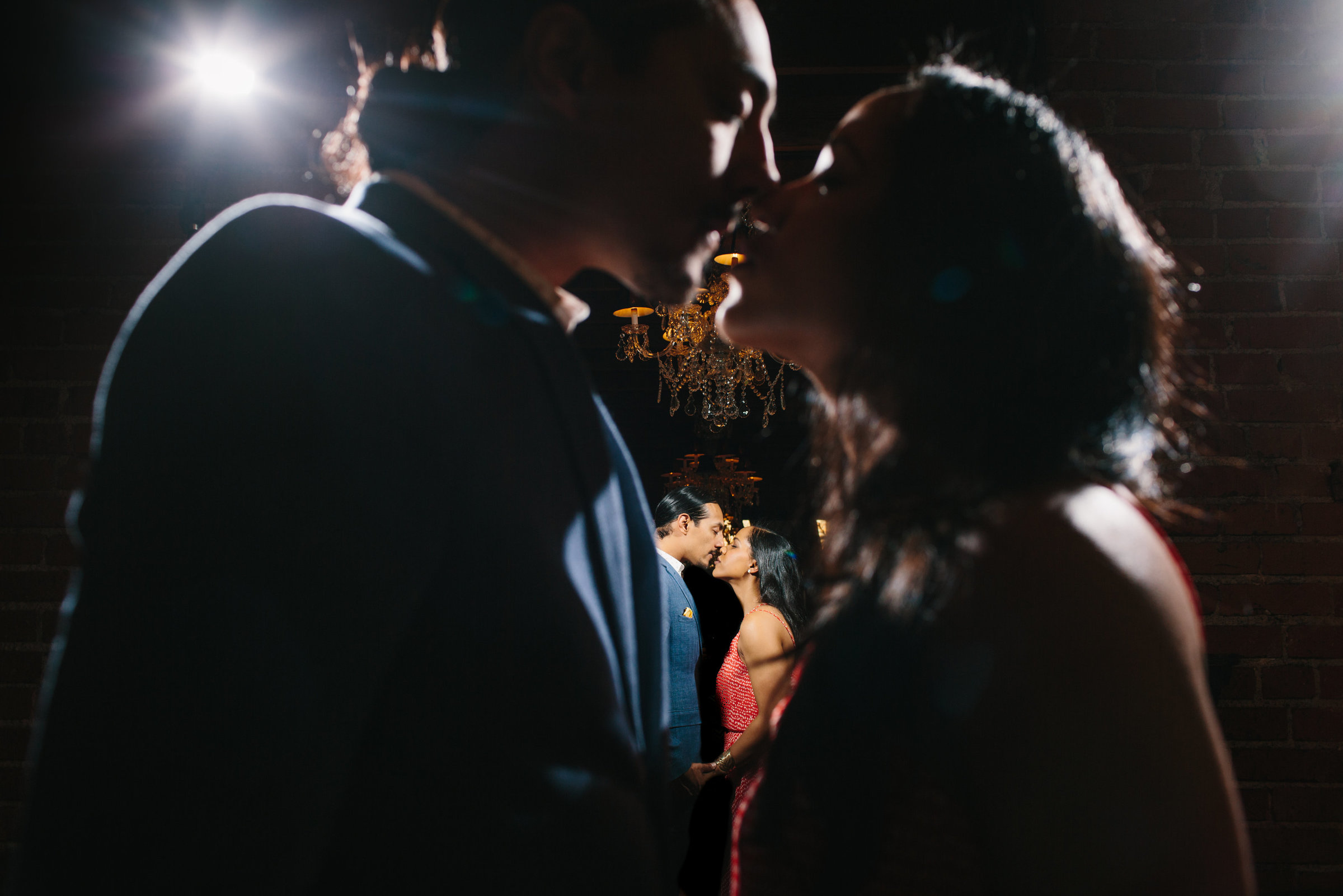 A creative engagement photo with couple kissing in mirror at Carondelet House in Los Angeles