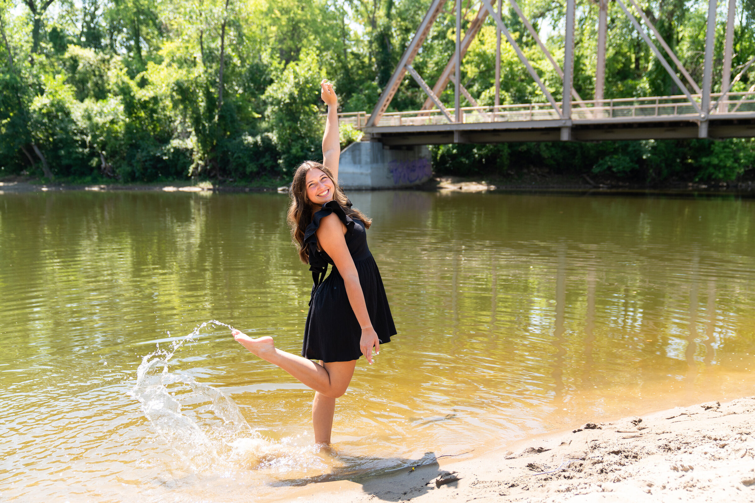 Girl kicks up water in celebration of her senior pictures