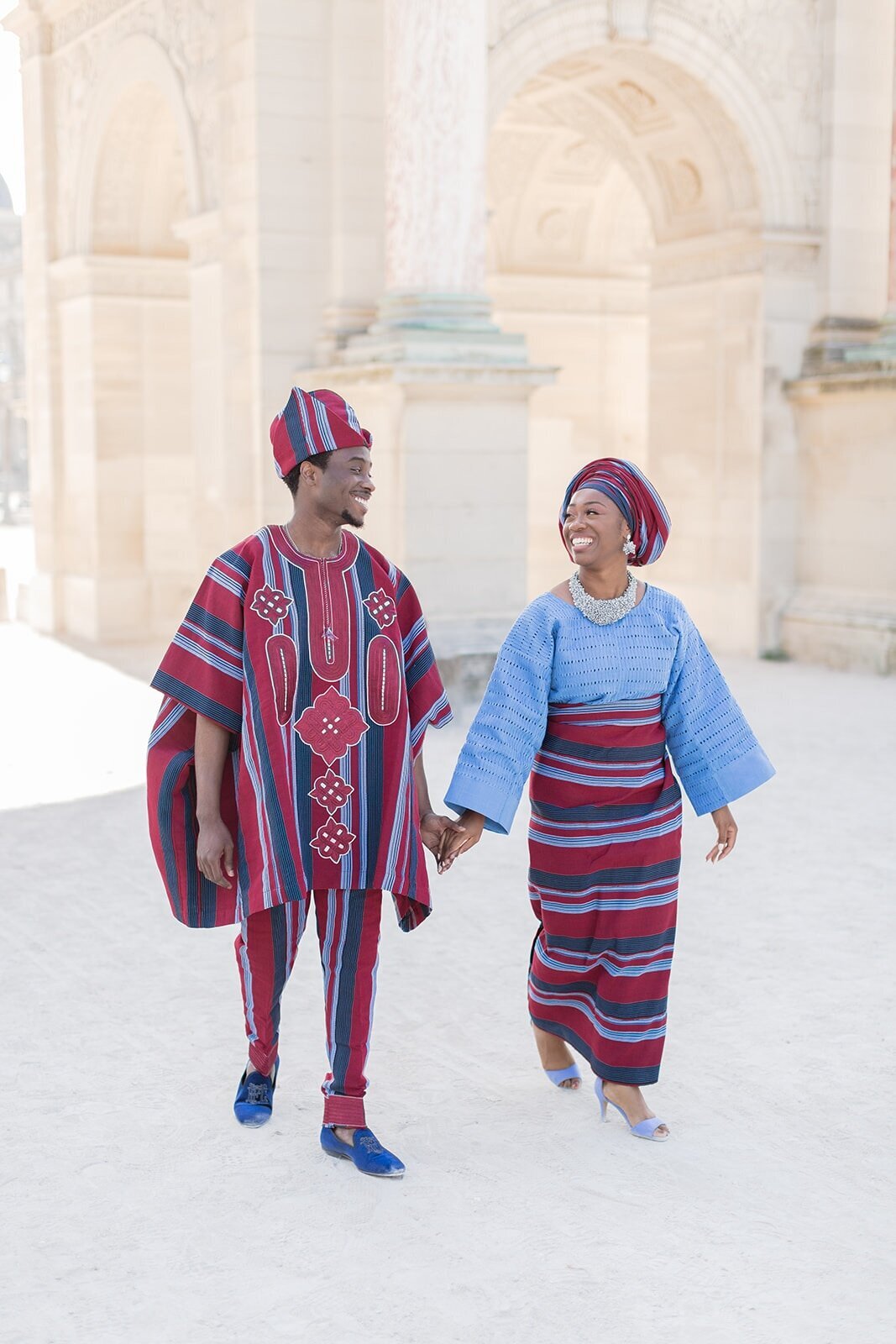 nigerian couple walk front of louvres museum paris