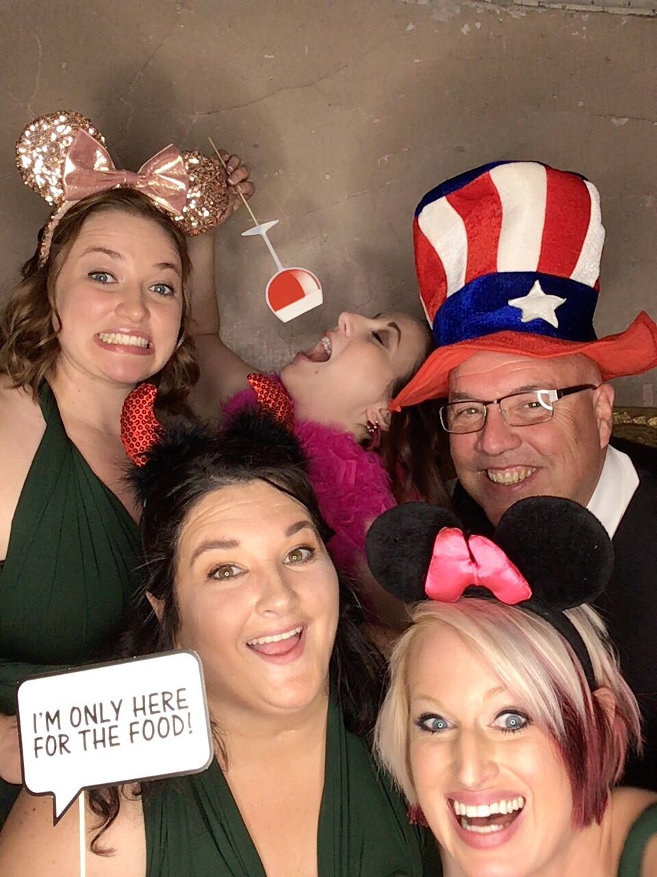 Group of 5 together in photobooth with props at Wilburn Street Studio wedding