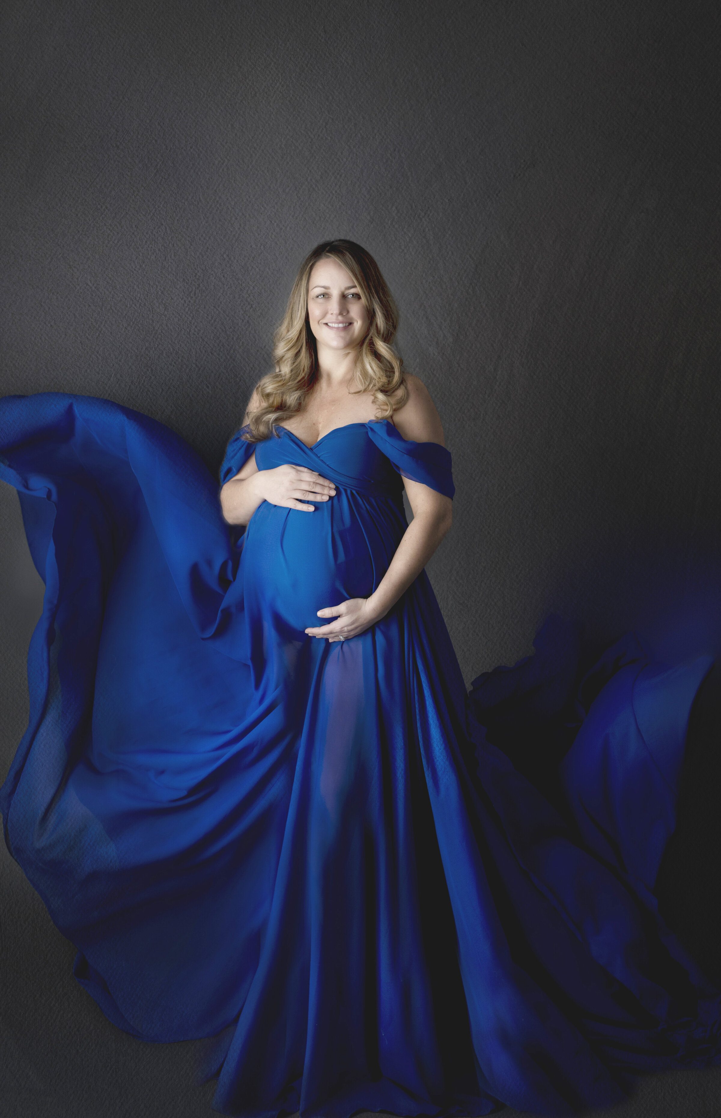 Maternity photo of women in royal blue  flowy dress in bucyrus ohio