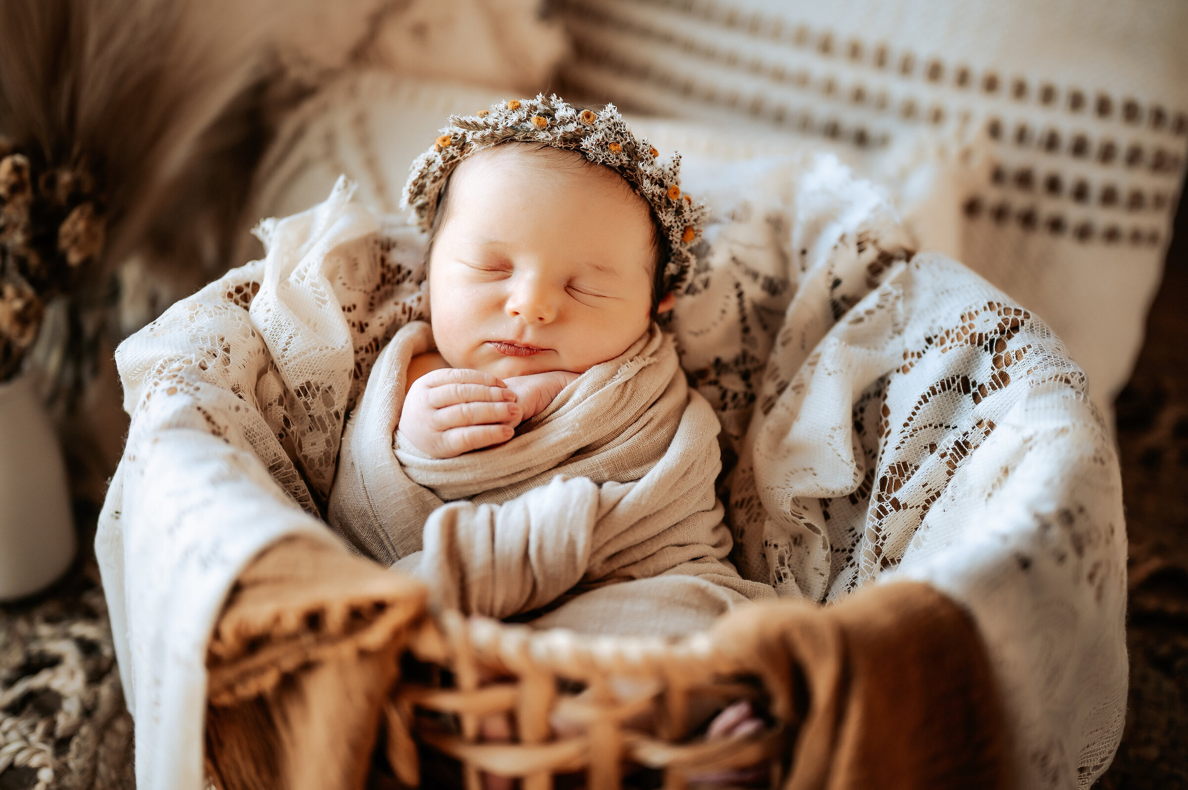 Photographer in Grant, Nebraska takes photos of newborn in boho basket and headband