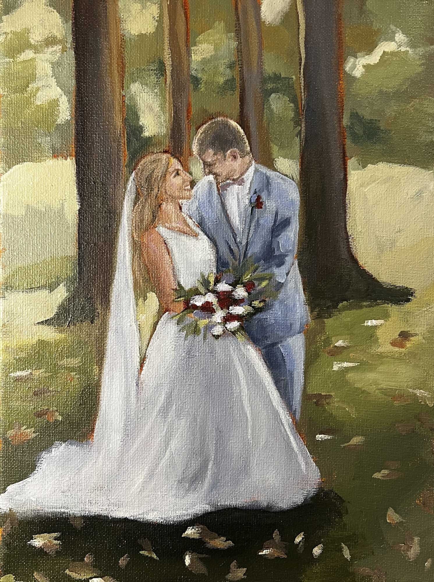 Bride and groom embracing outside under trees