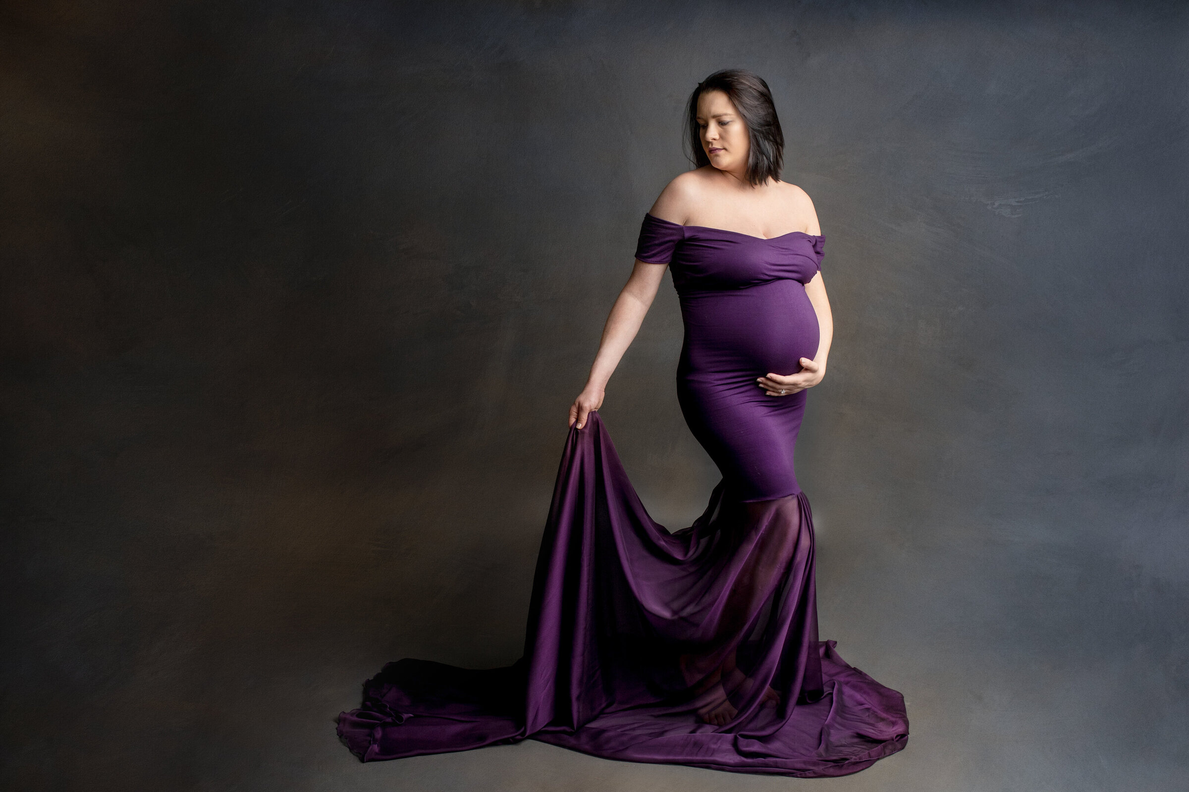 Maternity photo session of women in purple dress