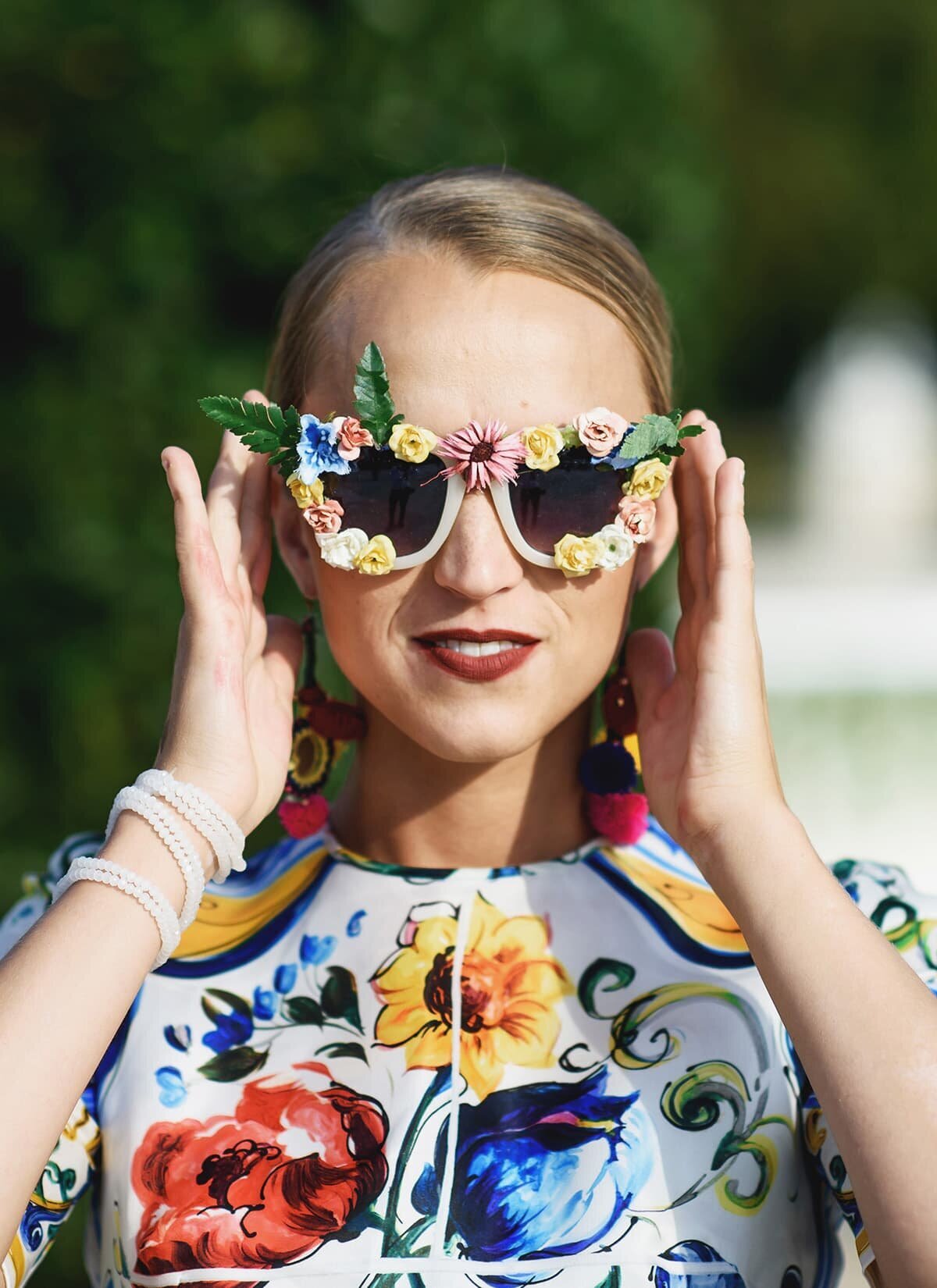 Woman wearing sunglasses decorated with flowers