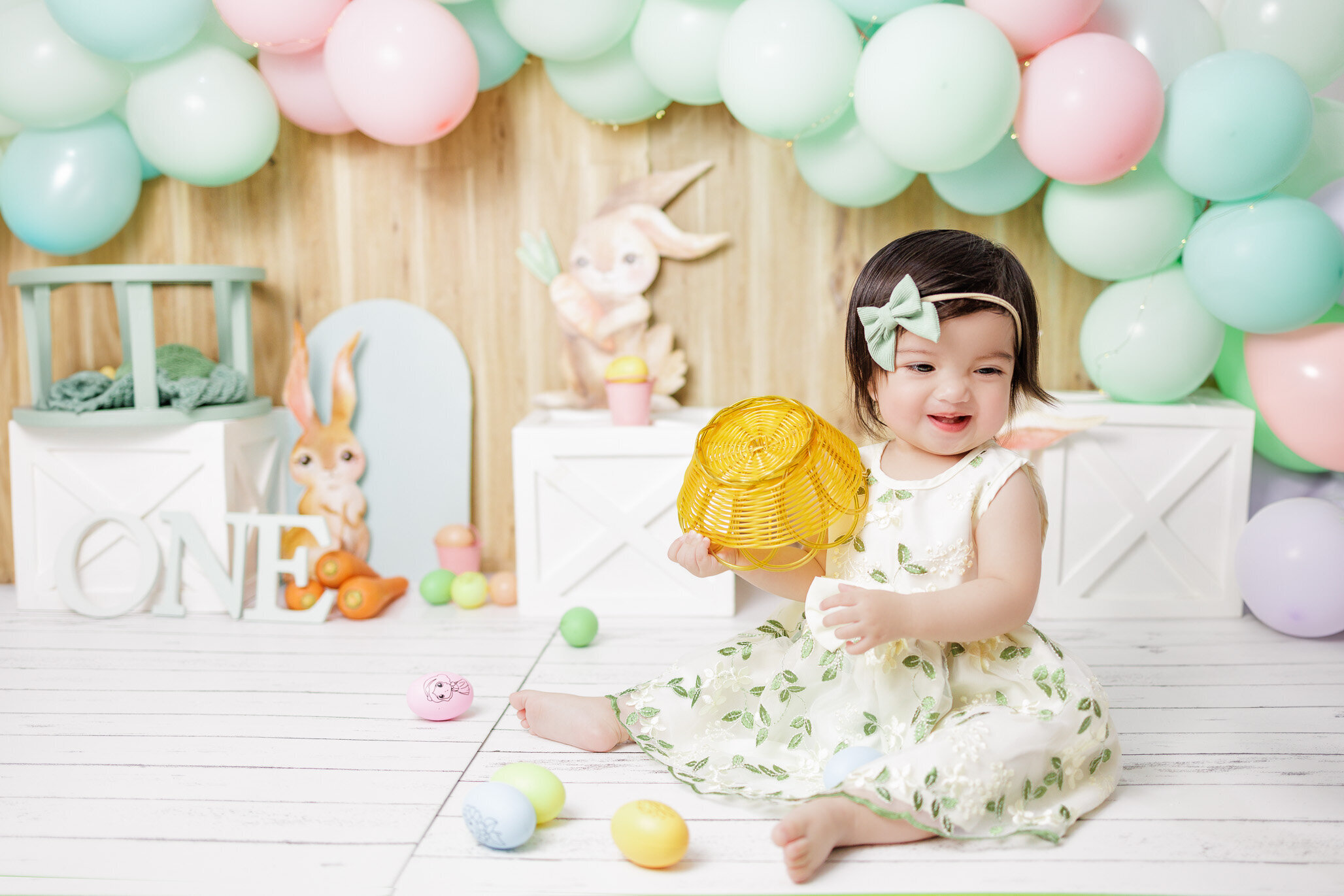 baby girl wearing sage green dress , pre-birthday photoshoot