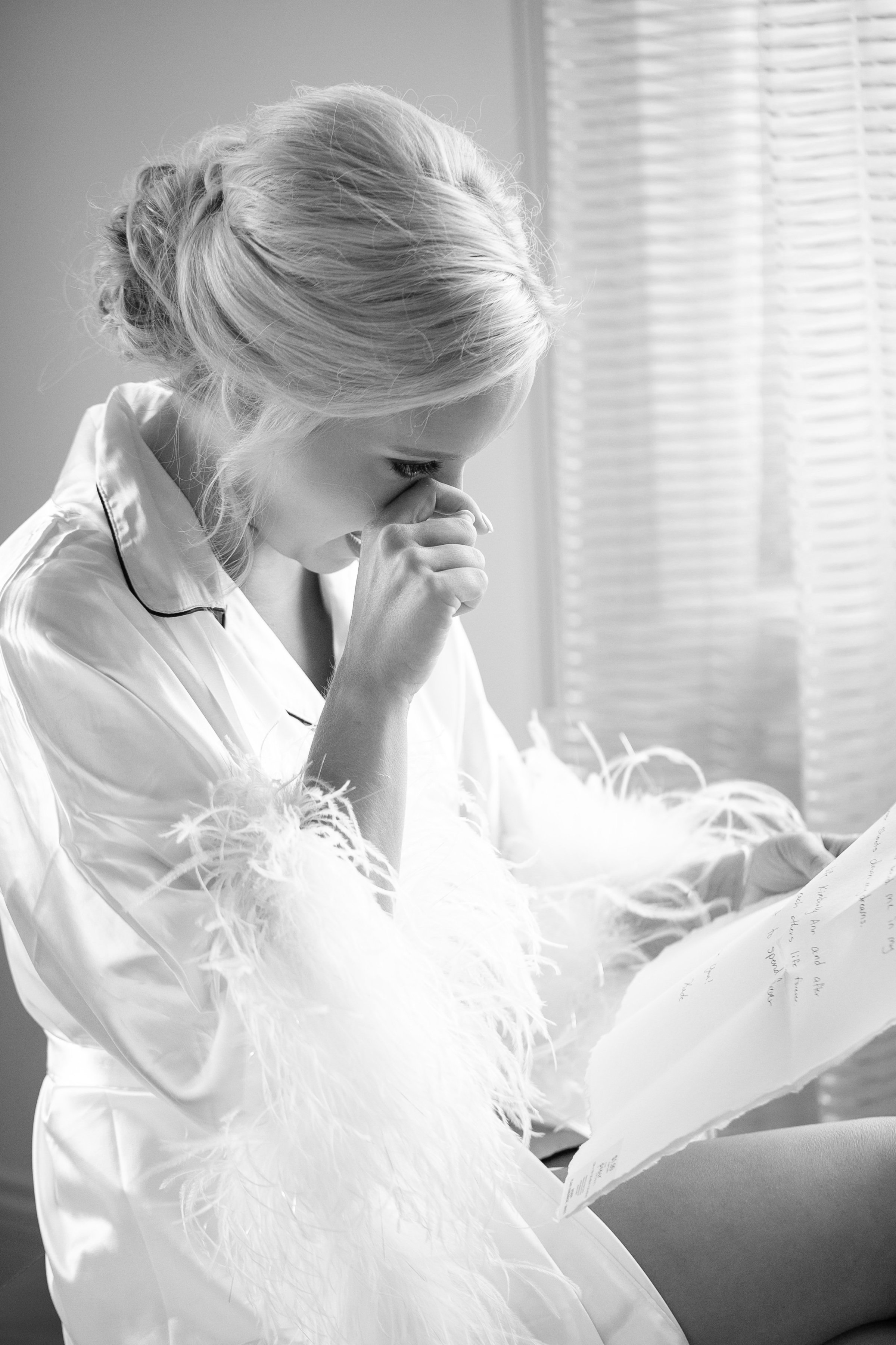 Bride reading note on wedding day