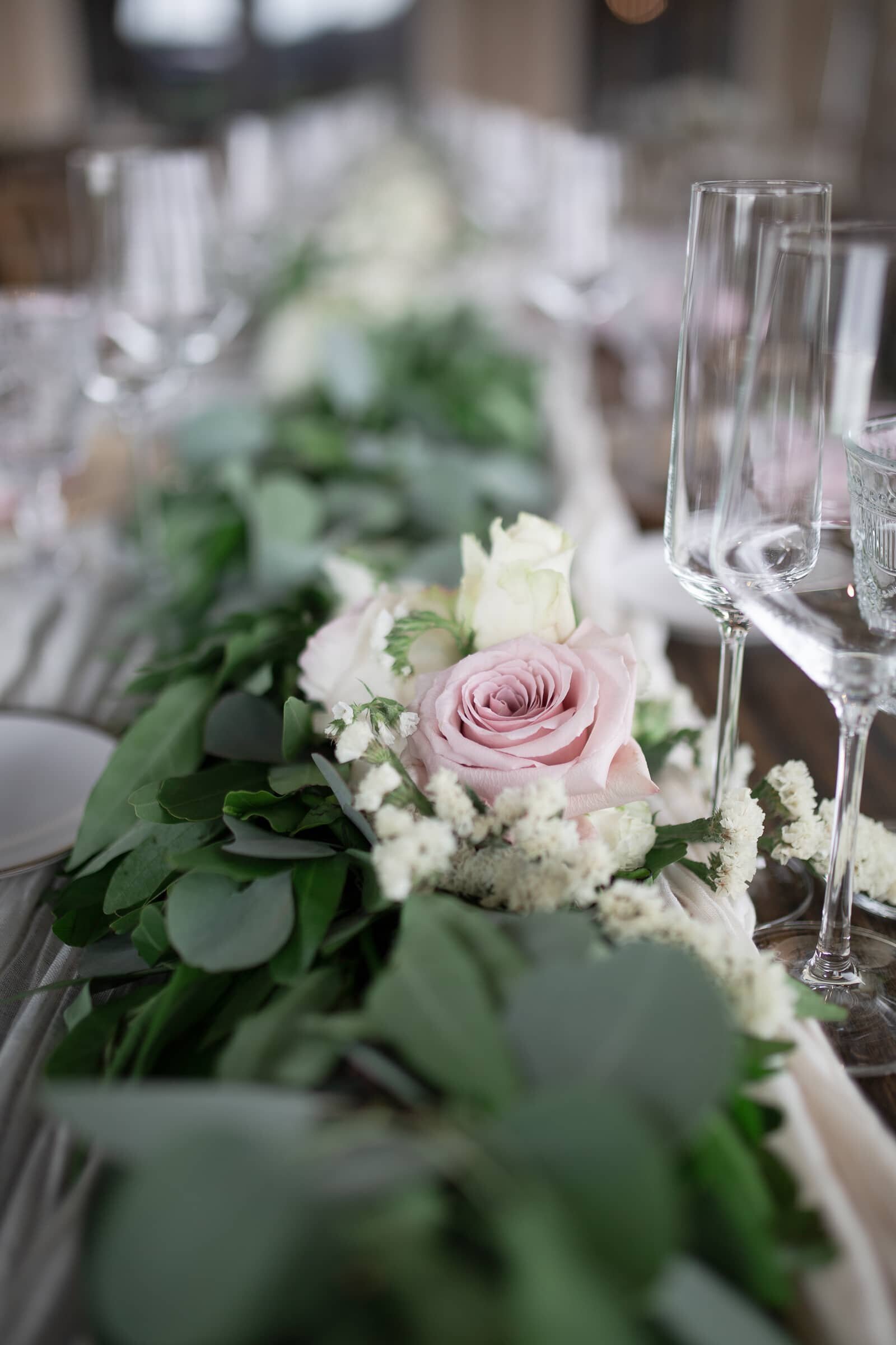 long farm table decor . Blush pink and white flowers among greenery. Timeless wedding photographer in Cary, NC.
