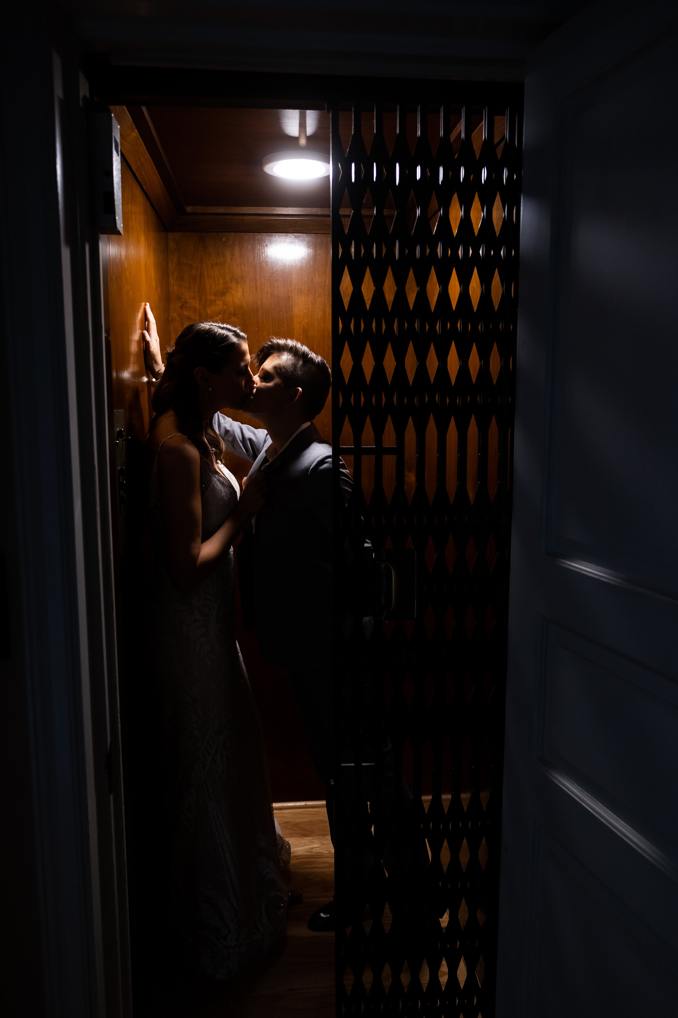 Wedding couple kissing in vintage elevator in Detroit