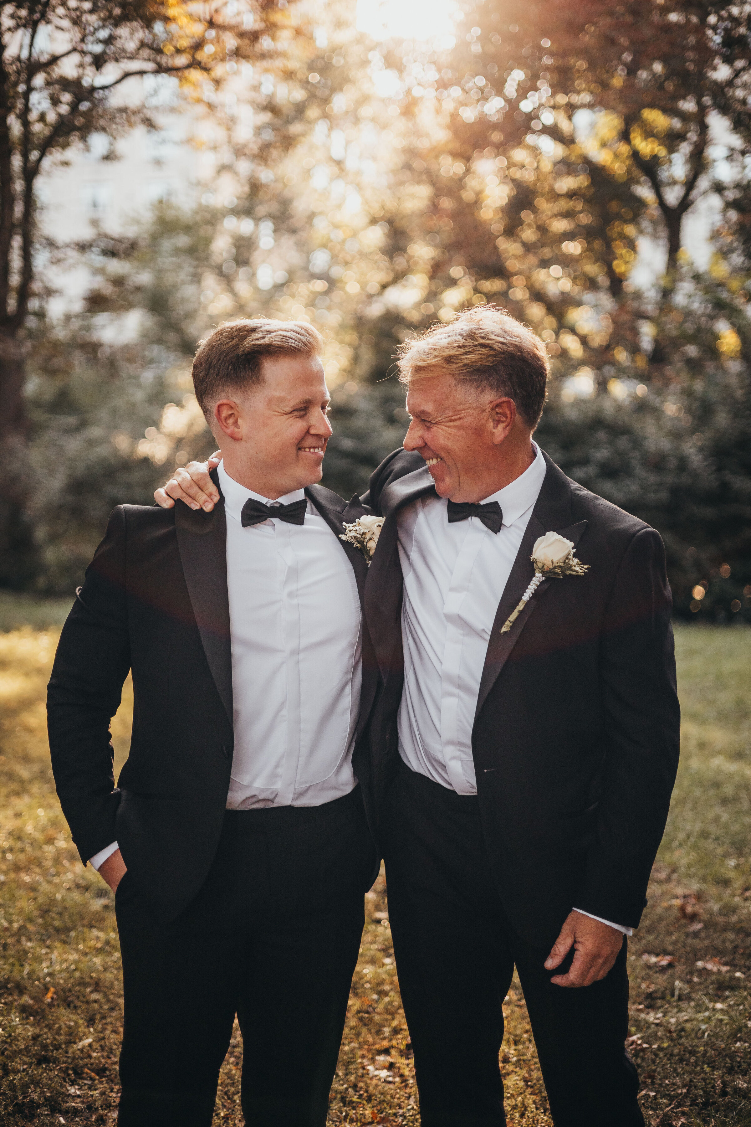groom and dad looking at eachother in central park