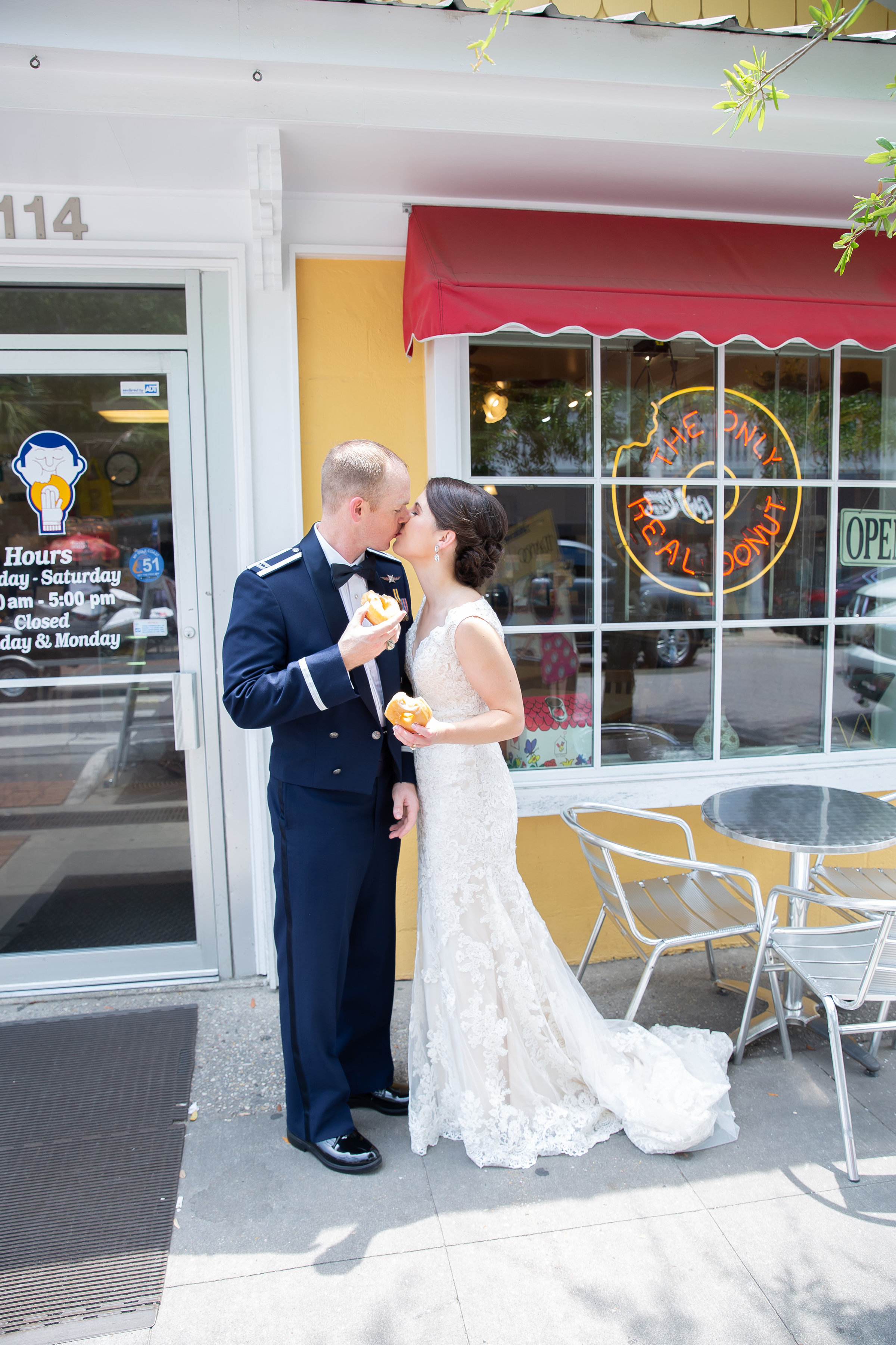 Photo of Bride and Groom in front of Tatonut in downtown Ocean Springs Mississippi