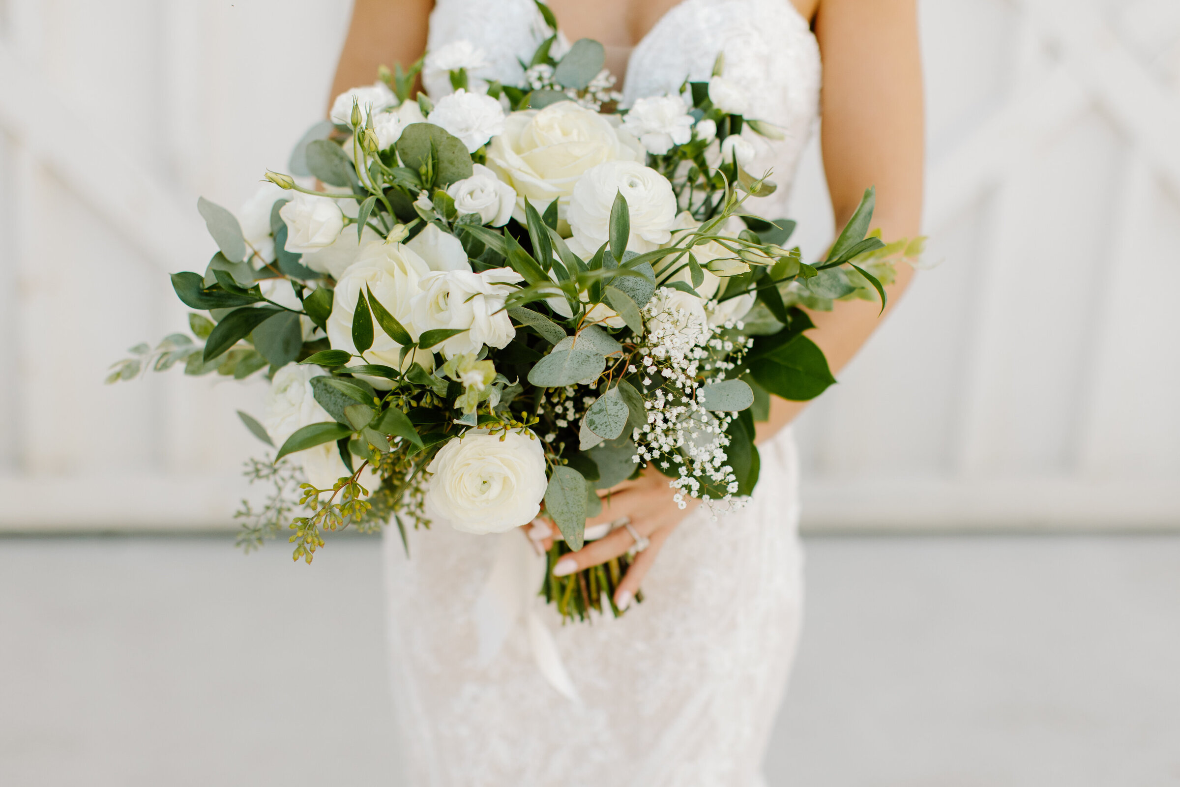 Bride holding timeless cream and greenery bouquet