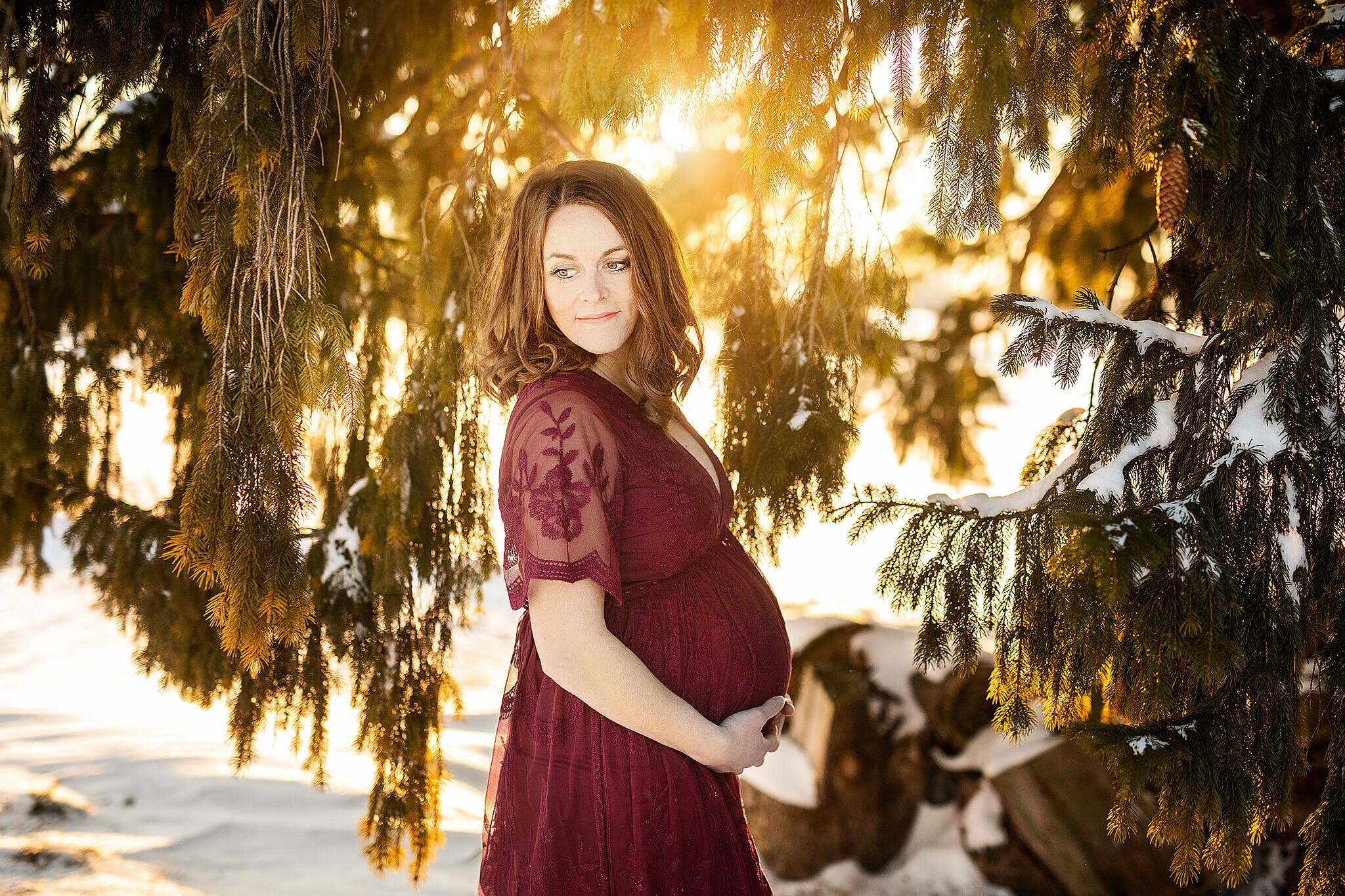 maternity photos  of women in red dress in winter in bucyrus ohio, photo done by erica finnan photography