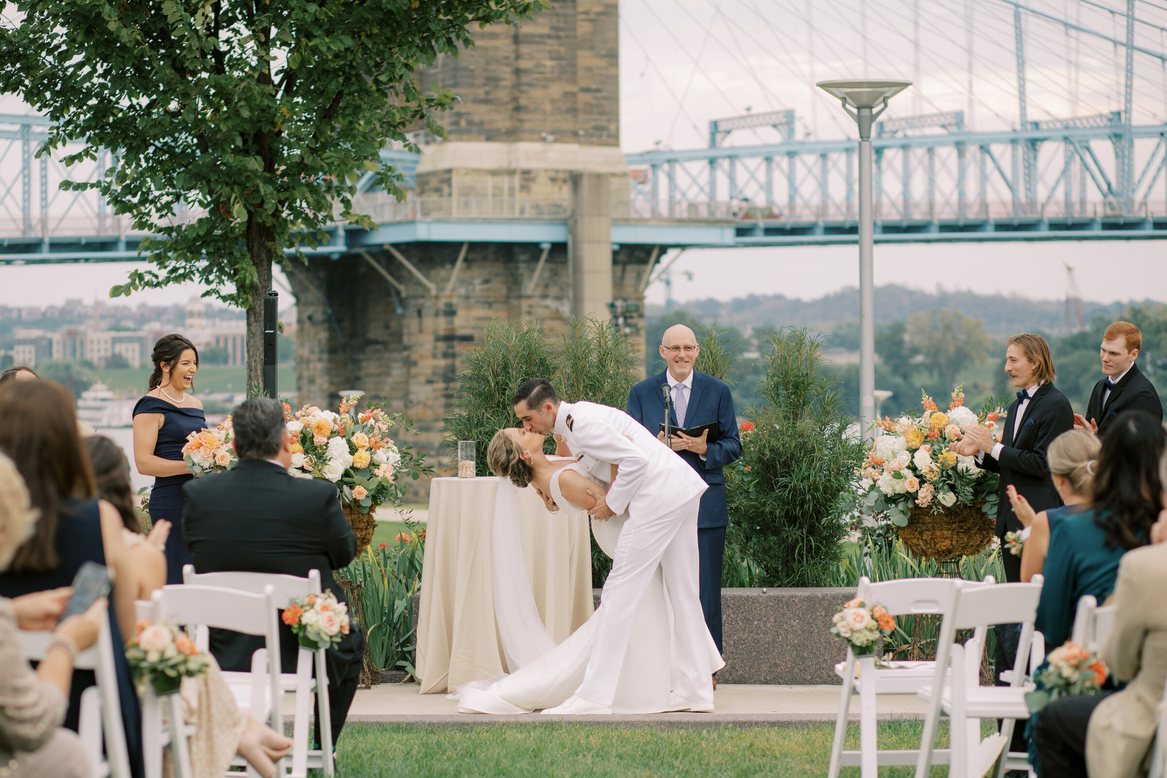 A couple shares their first kiss in front of the bridges downtown Cincinnati.