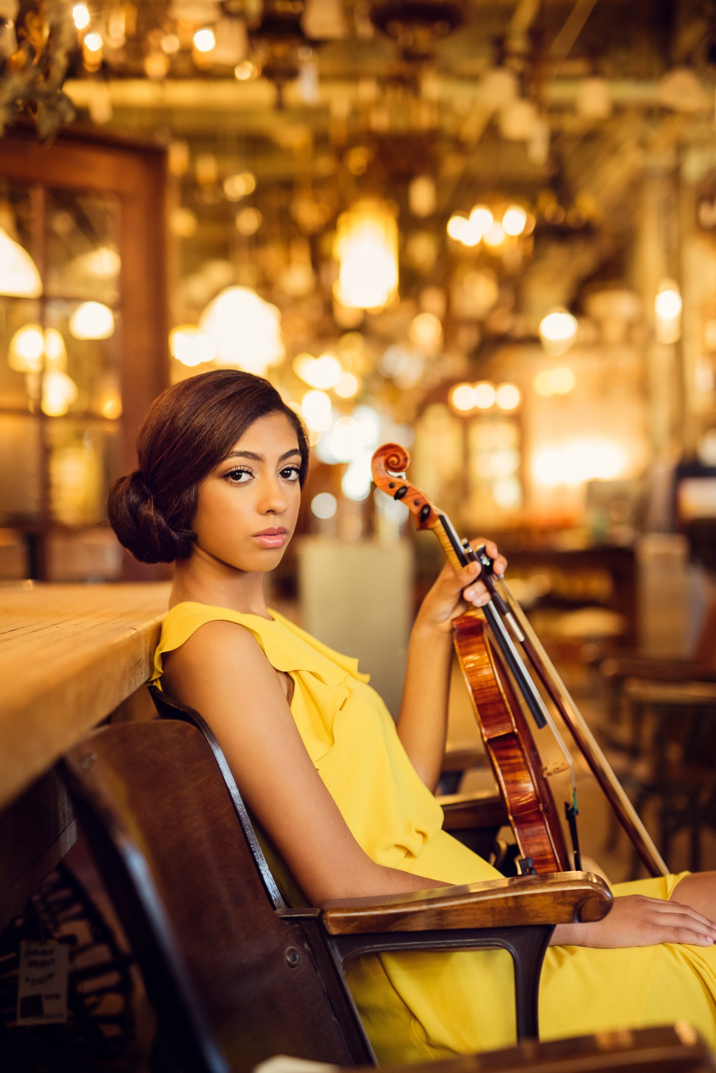 Edina Minnesota high school senior photo of girl in  architectural antiques wearing a yellow dress with violin
