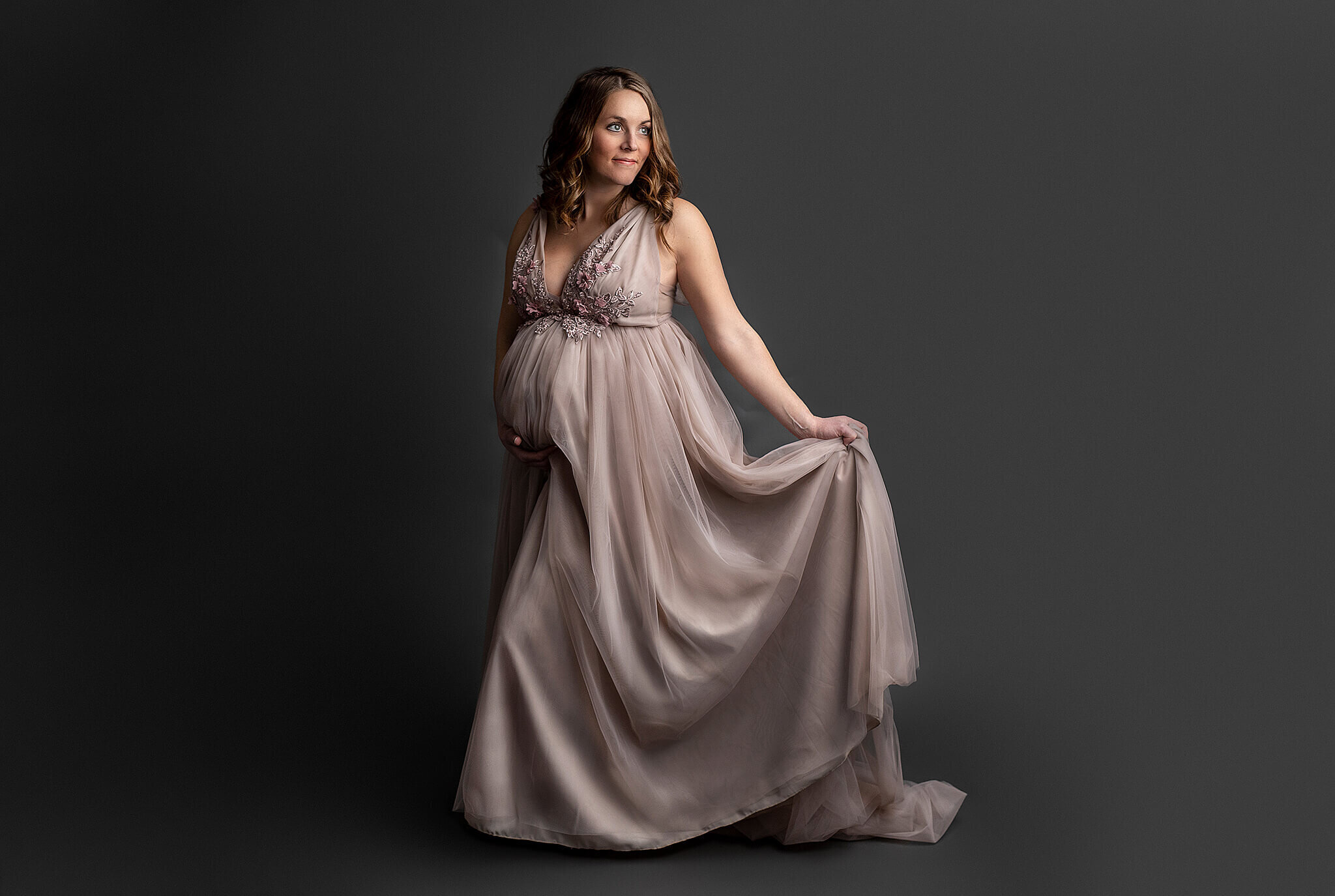 Pregnant women in flowy dress in bucyrus ohio photography studio