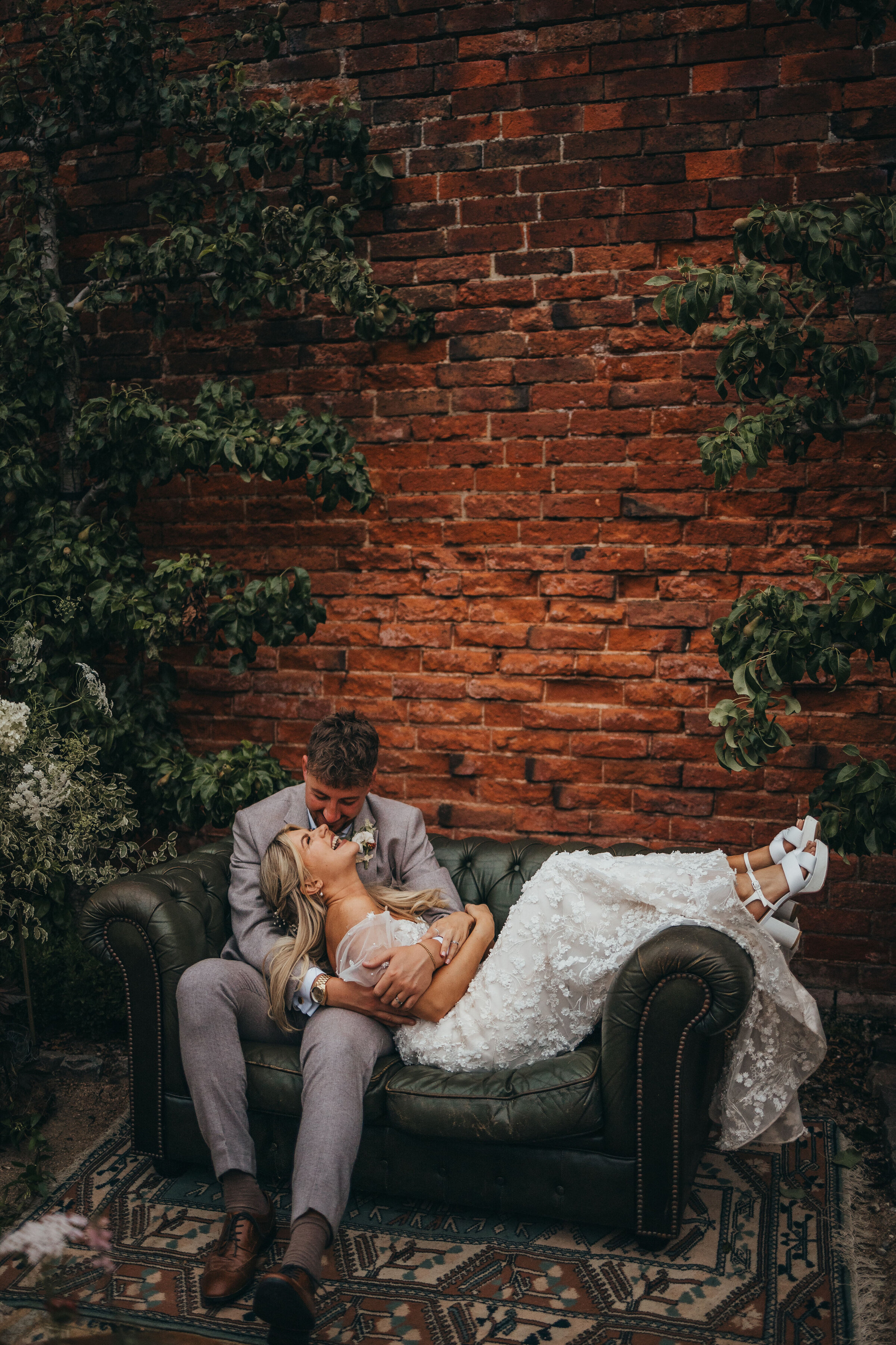 bride and groom on a sofa outide