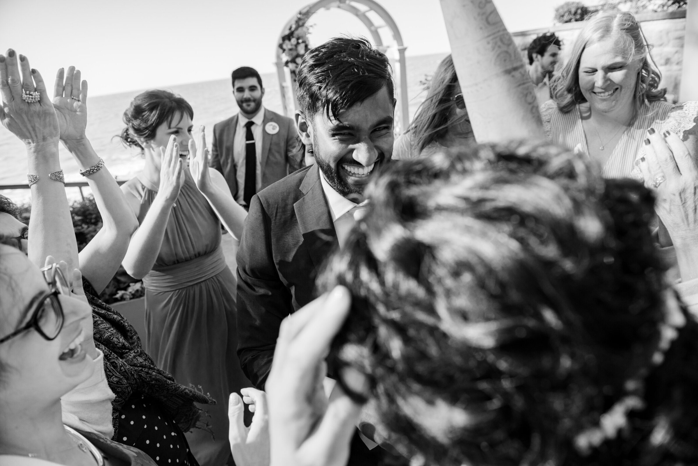 Ohio groom shares a dance with his bride on their wedding day, surrounding by all their friends and family during a private lakeside wedding in Rocky River, Ohio. Photo taken by Cleveland Wedding photographer Aaron Aldhizer