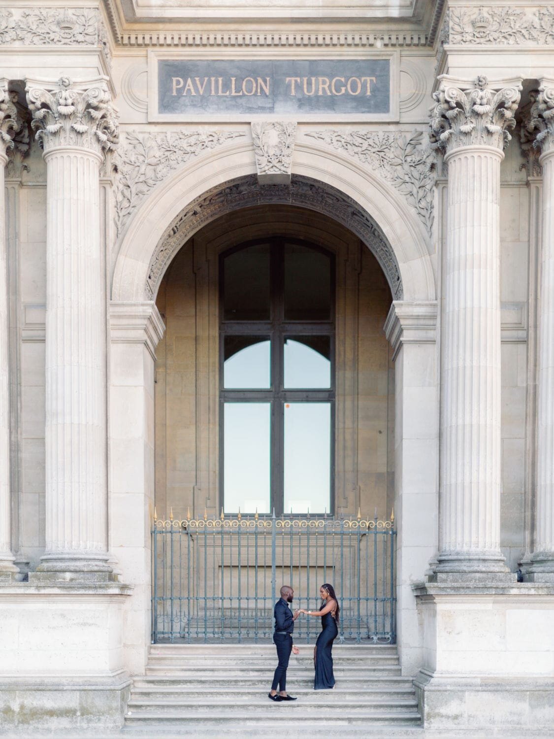 couple on stairs of louvres museum paris