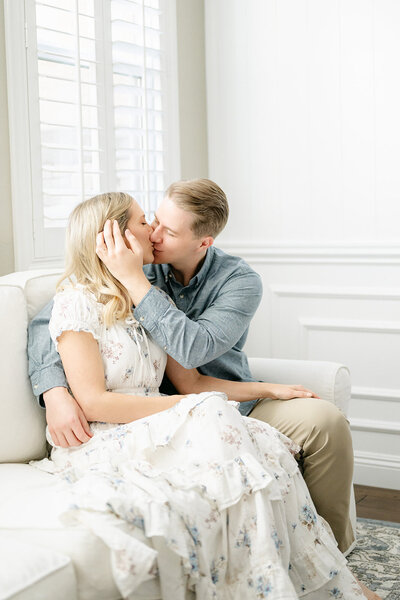 fallback shared on Invalid Date | A sweet couple sits on white couch and shares an intimate moment