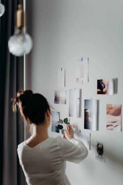 woman-putting-photo-on-wall-3585038